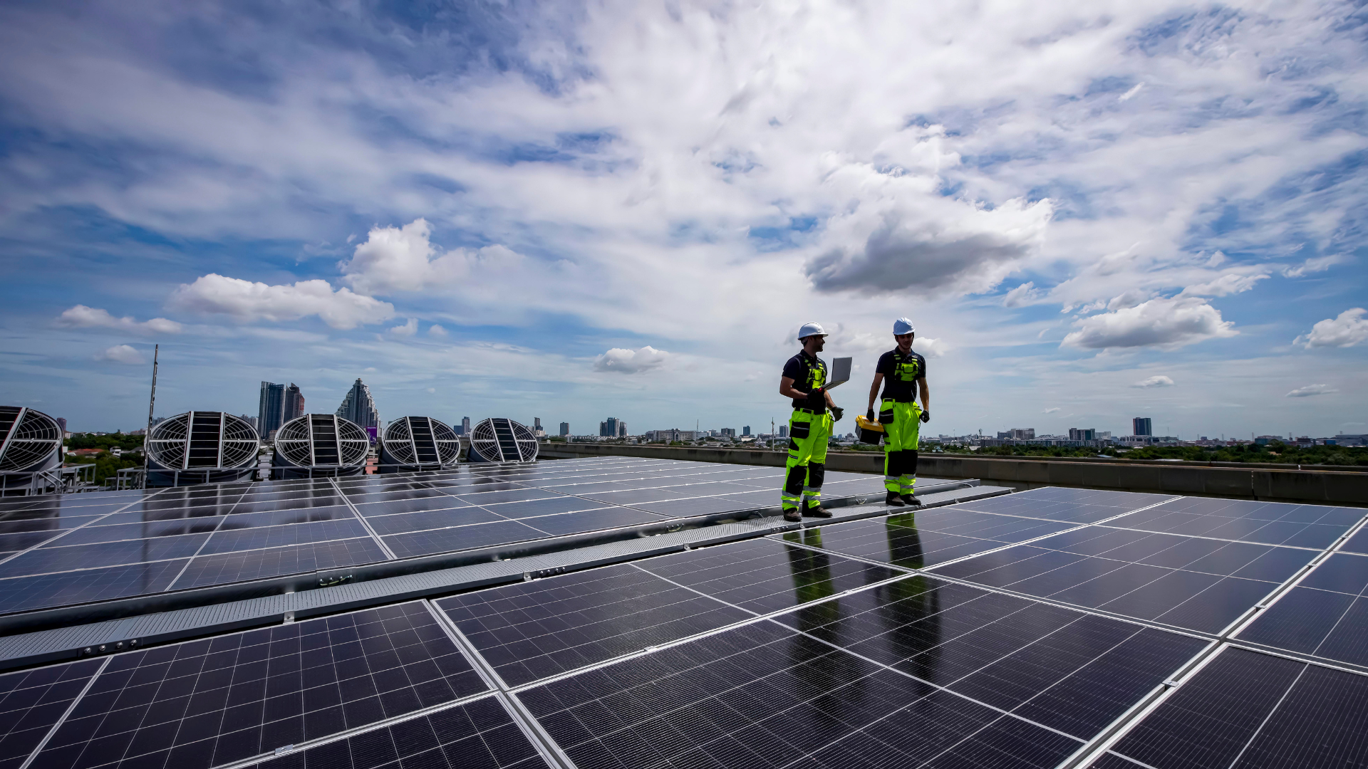 Engineer carrying a solar panel at a commercial warehouse site